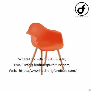 orange plastic armchair wooden legs
